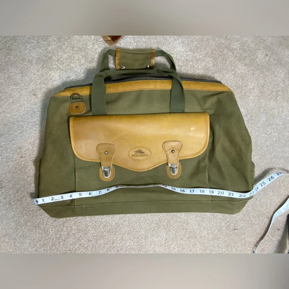 Vintage like new High Sierra leather and green canvas duffle bag.